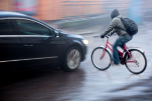 Personal Accident Lawyer Monmouth County, NJ - Bicyclist before being hit by car in rain